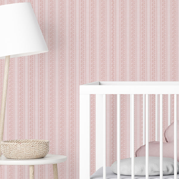 Soft pink nursery wallpaper with hand-drawn floral vines, narrow wavy stripe details, and a romantic cottagecore pattern for children’s bedrooms.