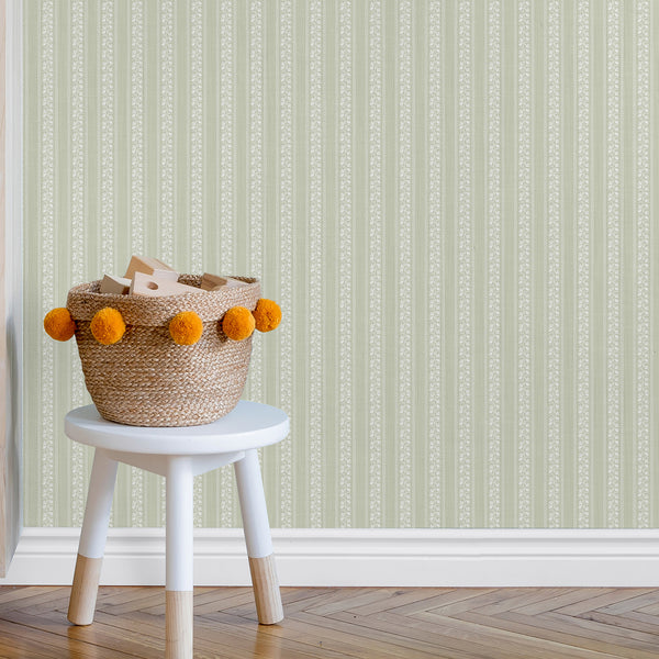 Farmhouse wallpaper with soft sage green floral stripe bands, white botanical motifs, and subtle textured detailing for French country and cottage interiors.