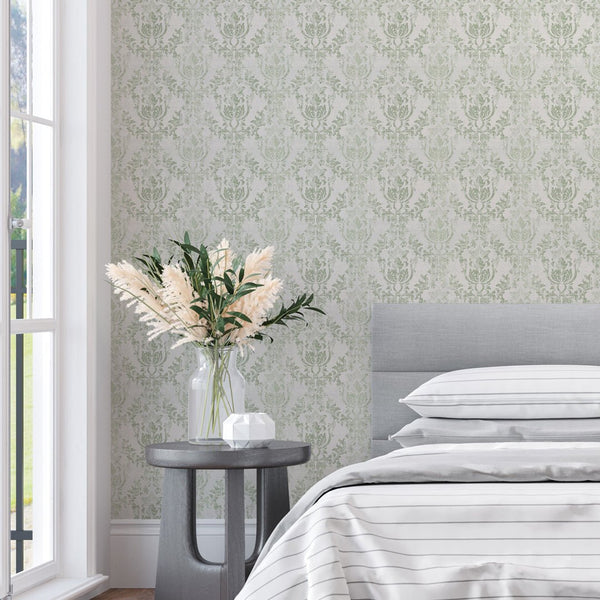 Close-up of ornate damask wallpaper with sage green motifs on cream, ideal for a refined dining room.