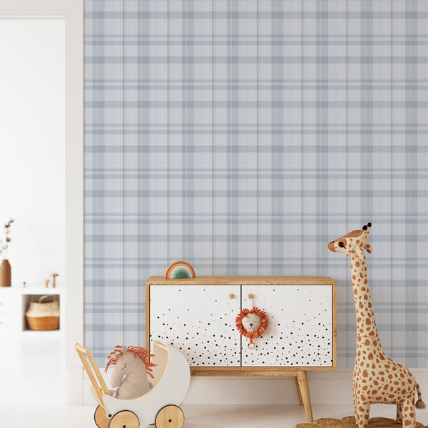 Self-adhesive wallpaper featuring a muted blue tartan grid, perfect for creating structure in a child's bedroom or entryway. Made in the USA with high-quality materials.