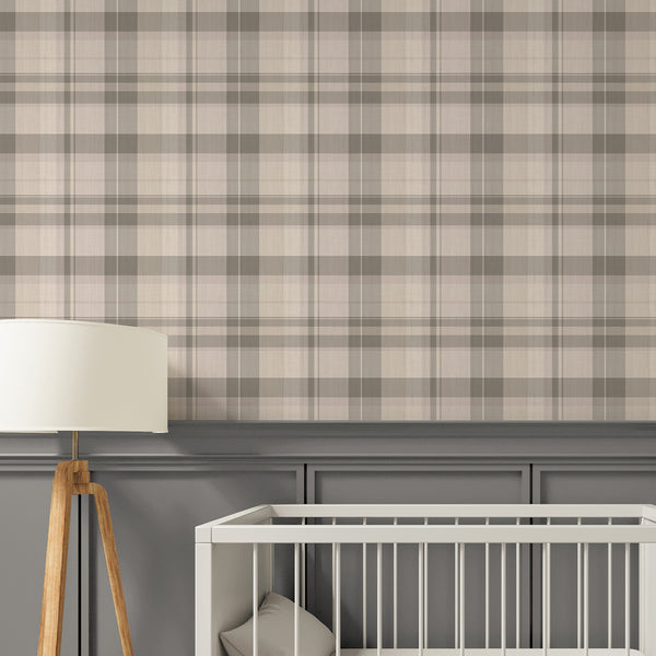 A styled nursery interior with a beige and gray plaid wallpaper pattern above gray wainscoting.