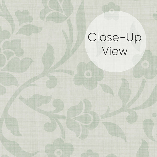 Close up of Sage green and ivory peel and stick wallpaper featuring a subtle floral damask pattern with stylized flowers, curved vines and a woven texture effect.