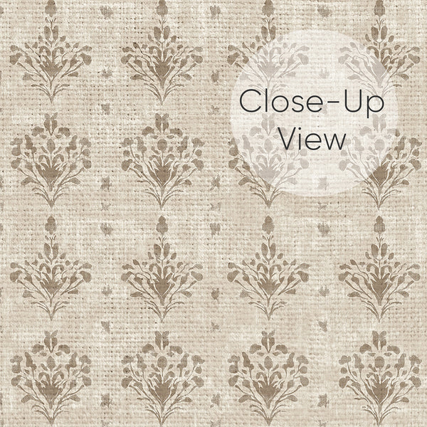 Close up of beige wallpaper with muted taupe damask floral motifs and a distressed aged finish, ideal for bedroom, dining room or living room walls.