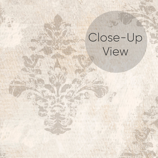 Close up of vintage damask wallpaper in warm beige and cream tones with faded ornamental details and an aged textured effect for French country home decor.