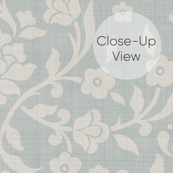 Close up of Vintage botanical damask wallpaper with ivory blossoms and scrolling leafy branches against a soft dusty blue background for cottagecore bedroom decor.