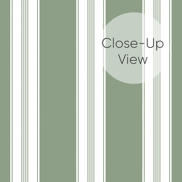 Close up of Removable wallpaper in muted green and white with alternating broad stripes and narrow pinstripe details for a modern bedroom accent wall.