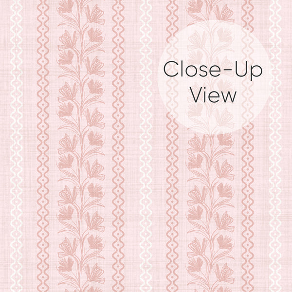 Close up of removable wallpaper in blush pink with dusty rose flowers, vertical botanical stripes, and playful curved borders for a girls nursery accent wall.
