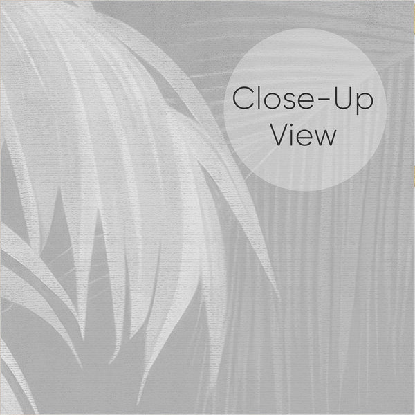 Close up of soft gray botanical wallpaper with elegant palm trees, feathery fronds and subtle layered tropical foliage on a muted neutral background.
