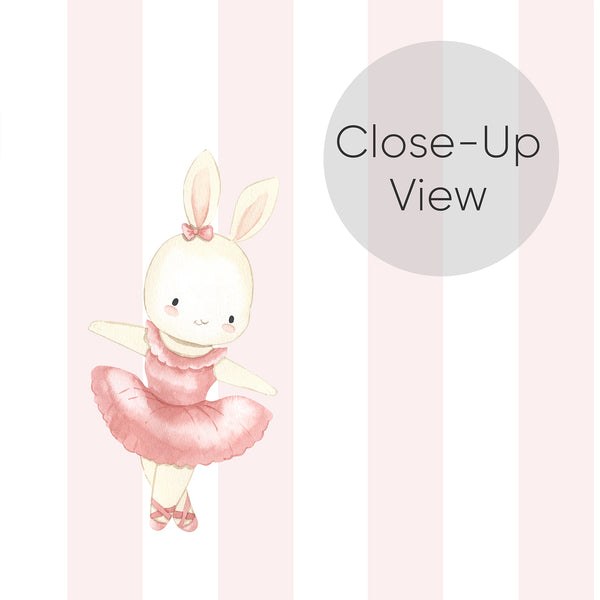 Close up of bunny nursery wallpaper featuring a sweet ballet rabbit on pastel pink striped wallpaper for a whimsical baby girl room or toddler bedroom.