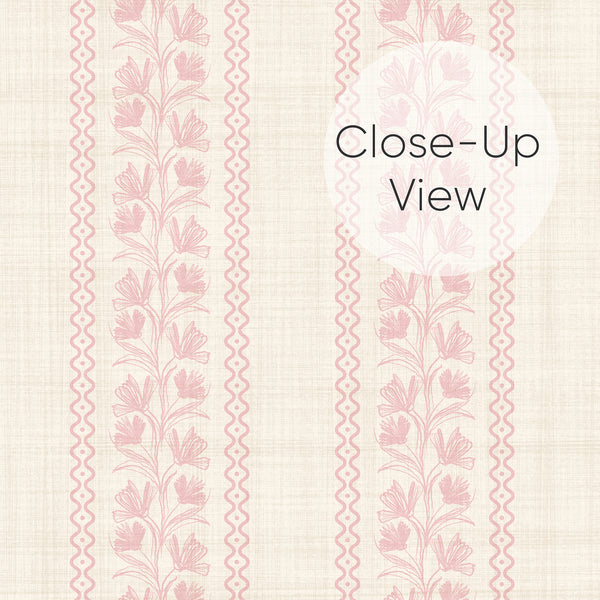 Close up of removable blush pink wallpaper with elegant vertical floral stripes, delicate botanical vines, and vintage-inspired charm for bedroom accent walls.