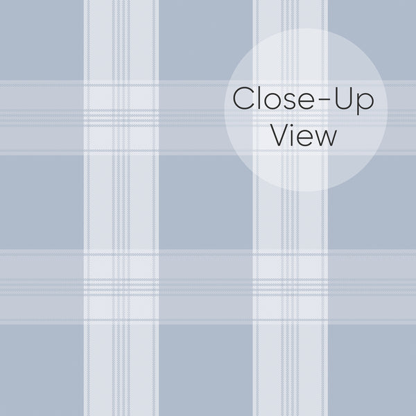 Close up of removable wallpaper in dusty blue and white with a classic plaid pattern and fine vertical and horizontal lines for a bedroom accent wall.