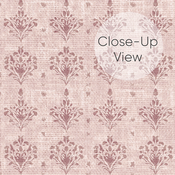 Close up of muted pink floral wallpaper with elegant damask motifs and an aged distressed effect, perfect for a vintage bedroom, powder room or accent wall.