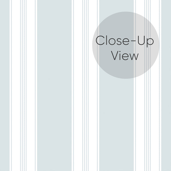 Close up of removable wallpaper in pale blue and white with alternating wide stripes and narrow pinstripe details for bedrooms, living rooms, and home offices.