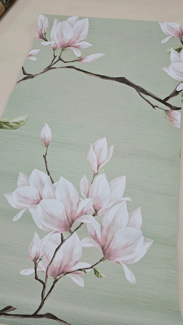 Botanical wall mural with soft-edged pink blossoms on a sage grasscloth texture, perfect for a home office or hallway. The medium-scale design adds a touch of elegance and continuity across panels. Made in the USA with high-quality, eco-friendly materials, it offers a temporary yet stylish solution for those seeking a minimalist, floral interior design.