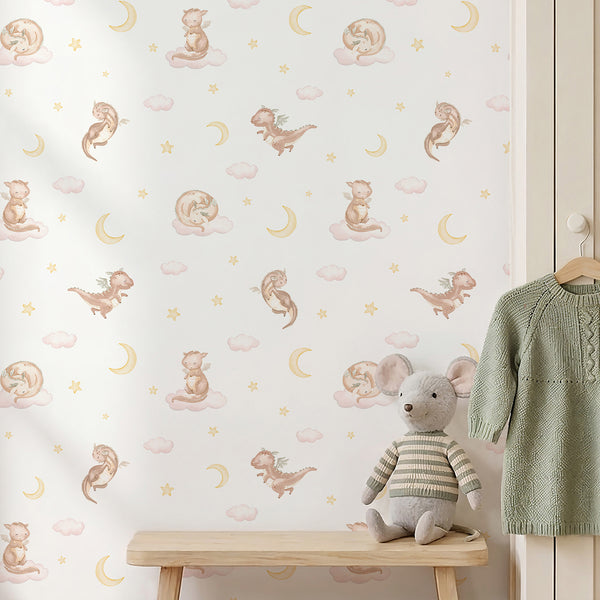 Storybook dragon wallpaper in soft beige, blush pink and yellow tones featuring an adorable flying dragon theme for a nursery or playroom.