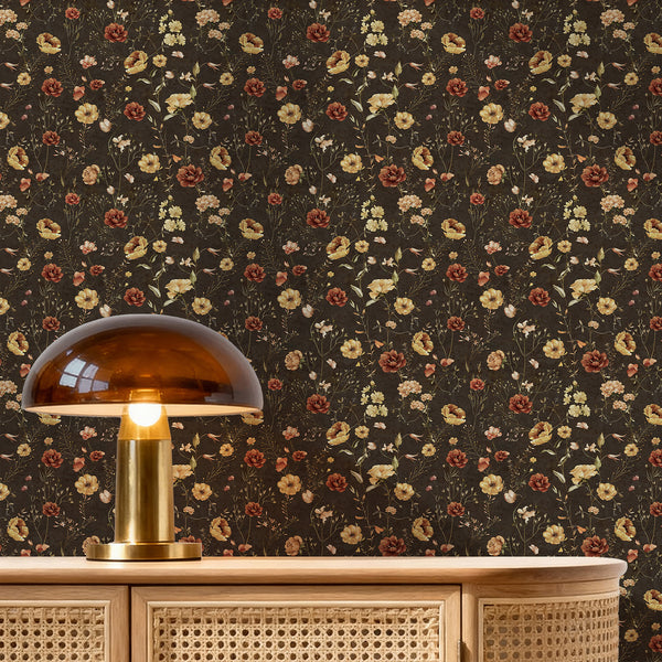 Dark wildflower wallpaper with rust, mustard, cream, and blush watercolor blooms on a deep brown background, ideal for a moody cottagecore bedroom.