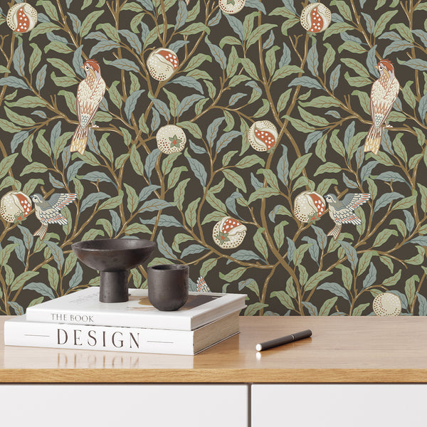 Stylized pomegranate and bird motifs on a dark brown backdrop create a classic wall covering. The vertical and diagonal rhythm, with muted greens and soft reds, suits English cottage interiors. This high-quality wallpaper is easy to apply and reposition, offering timeless elegance for bedrooms and living rooms.
