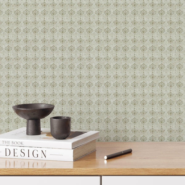Sage green damask wallpaper with faded floral ornaments and a distressed neutral texture, ideal for a French country bedroom or living room interior.