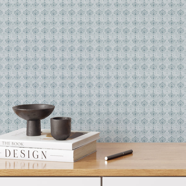 Dusty blue damask wallpaper with a small repeating floral motif and softly distressed texture, ideal for French country bedroom and cottagecore decor.