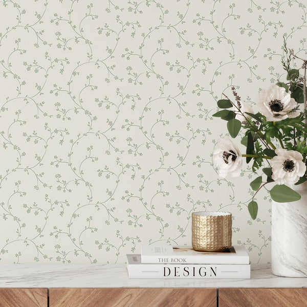 Botanical wallpaper featuring hand-drawn vines in muted green on a pale cream background, perfect for adding a light, airy feel to bedrooms or hallways. This eco-friendly, peel and stick wallpaper is ideal for renters looking for a temporary, nature-inspired decor solution.