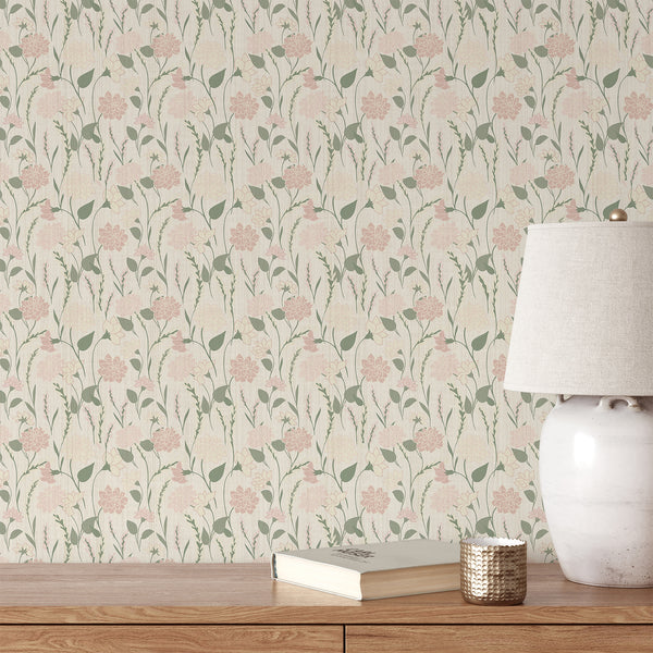Sage green and dusty pink floral wallpaper with delicate flowers, leafy stems and a soft textured cream background for boho bedroom decor.