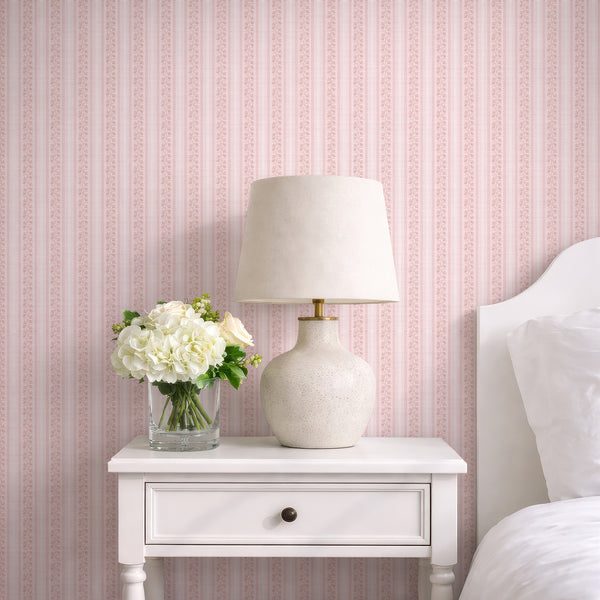 Blush pink floral stripe wallpaper with hand-drawn botanical stems, soft textured background, and wavy ric rac borders for a romantic nursery.