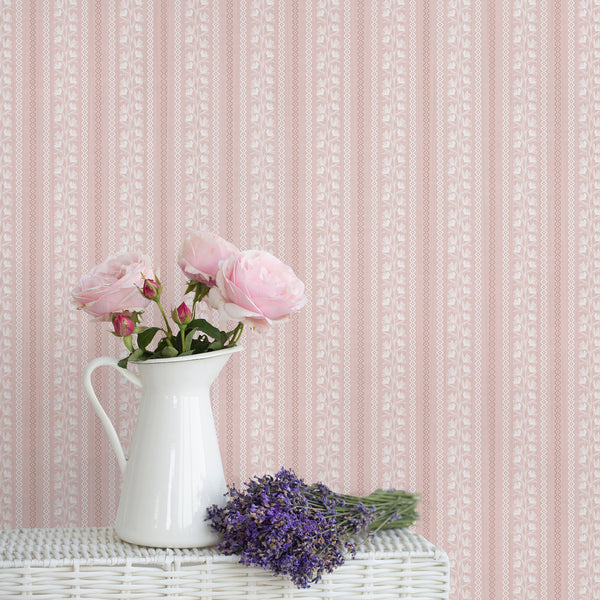 Dusty pink floral stripe wallpaper with white botanical vines, warm rose wavy borders, and a softly textured background for nursery or bedroom decor.