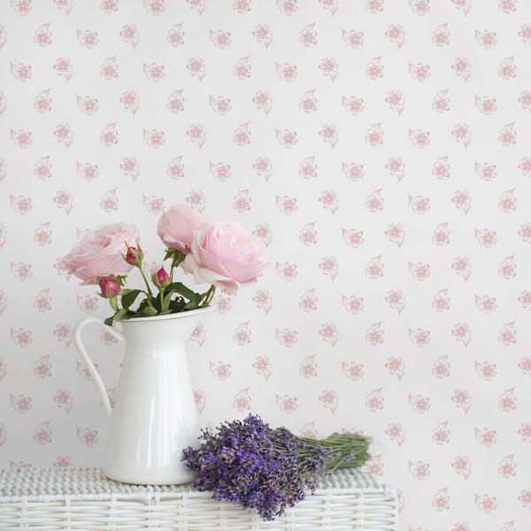Delicate pink floral wallpaper featuring small hand drawn blossoms on a crisp white background for minimalist, cottagecore and feminine interiors.