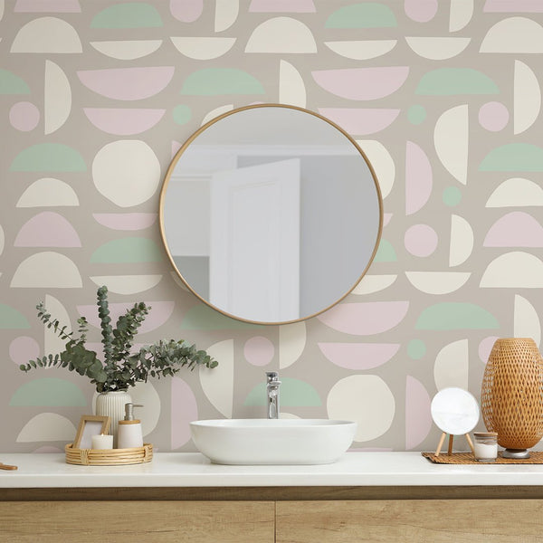 Pastel colored stones wallpaper with geometric circles and semicircles in mint, blush pink, and taupe. Perfect for adding a cheerful, modern touch to bathrooms or nurseries, this removable peel and stick wallpaper offers a playful yet orderly decor option in Scandinavian or mid-century themes.