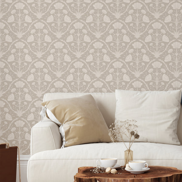 Beige vintage floral wallpaper featuring stylized blooms and scrolling acanthus motifs, ideal for adding a classic touch to living rooms. The tonal beige palette with darker linework suits cottagecore and French country interiors.