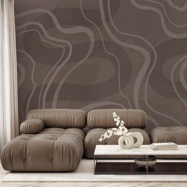 Brown abstract wallpaper featuring large flowing curved lines in taupe and beige tones with a subtle textured finish for a modern neutral interior.