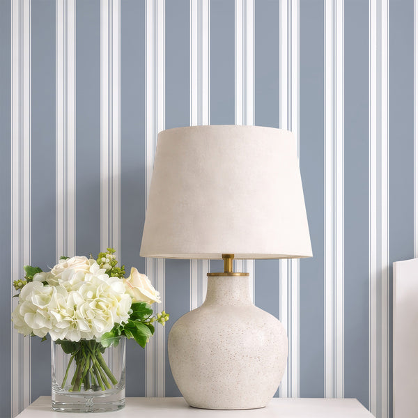 Minimalist blue wallpaper featuring a timeless vertical stripe pattern with slim white pinstripe accents for living rooms, bedrooms, or entryways.