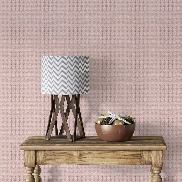 Dusty rose pink damask wallpaper featuring repeating floral ornaments and a weathered texture for romantic French country and cottagecore interiors.