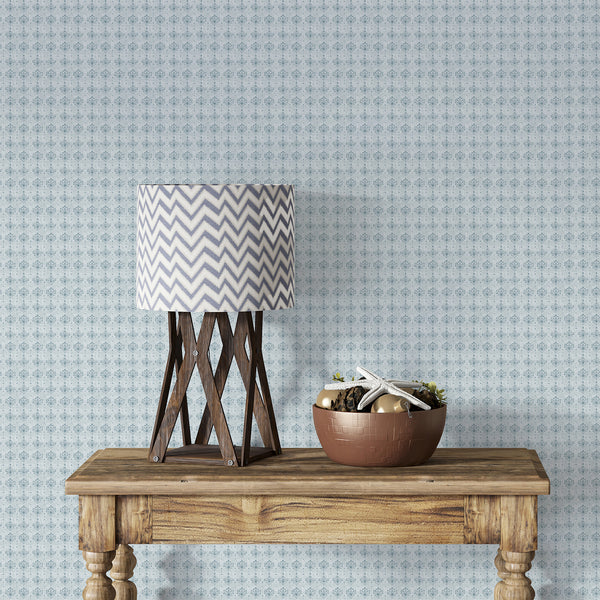 Small repeating damask wallpaper in muted dusty blue with vintage floral motifs and a softly weathered texture for cottagecore and classic home decor.