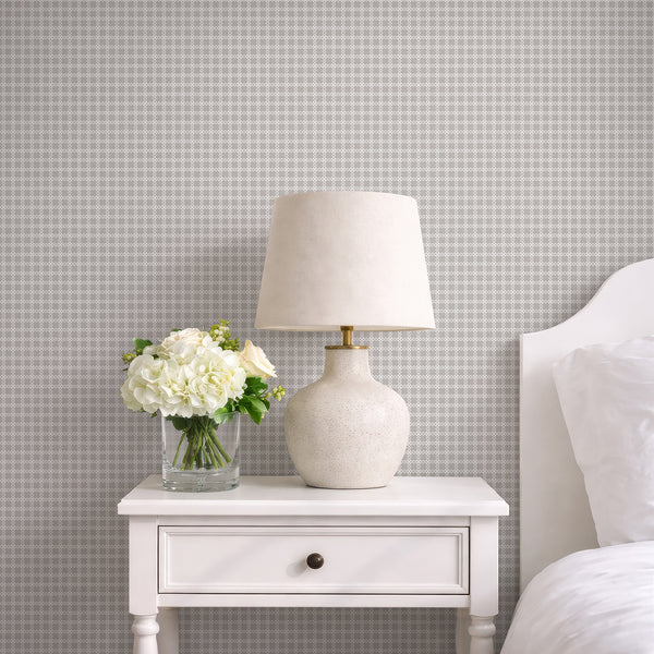 Neutral patterned wallpaper with a soft gray textured background and repeating white geometric trellis design for modern minimalist interiors.