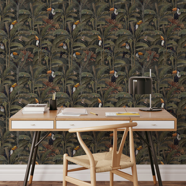 Moody tropical wallpaper featuring detailed jungle vegetation, broad banana leaves and vibrant toucans for vintage-inspired maximalist interior design.