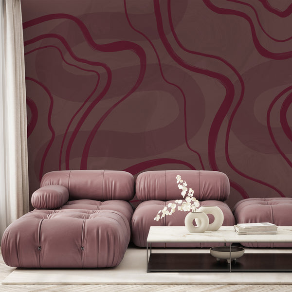 Burgundy and dusty mauve abstract wallpaper featuring oversized flowing curved lines and subtle texture for a modern minimalist bedroom interior.