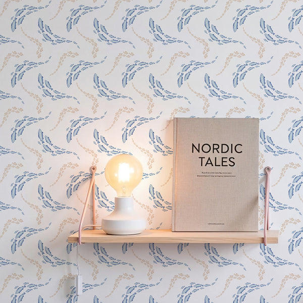 Watercolor fish wallpaper with playful swimming groups in soft blue and beige tones, perfect for an ocean nursery or kids bedroom accent wall.