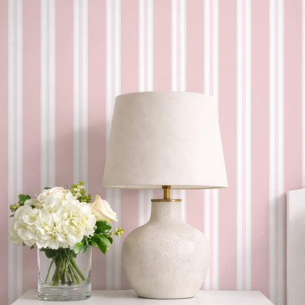 Soft pink pinstripe wallpaper featuring crisp white vertical stripes and fine linear accents for a minimalist nursery or girls bedroom wall.