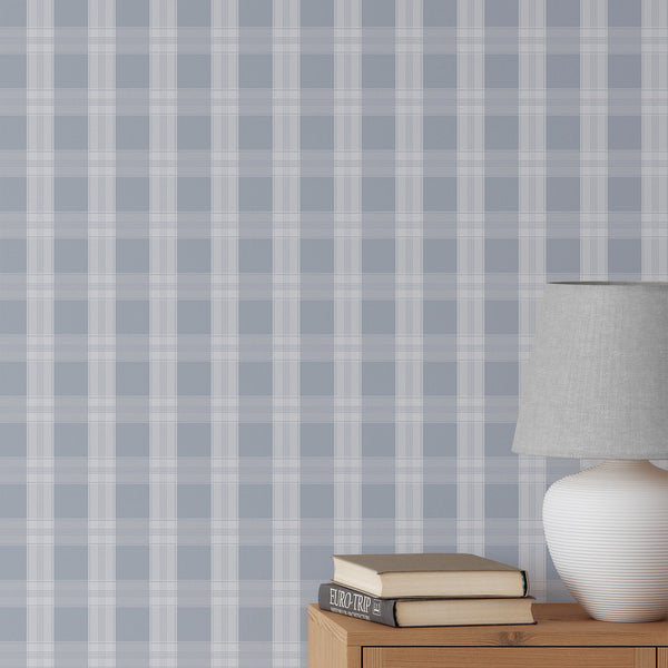 Dusty blue plaid wallpaper with soft white check lines and an oversized grid pattern, creating a clean preppy look for a nursery, bedroom, or living room.
