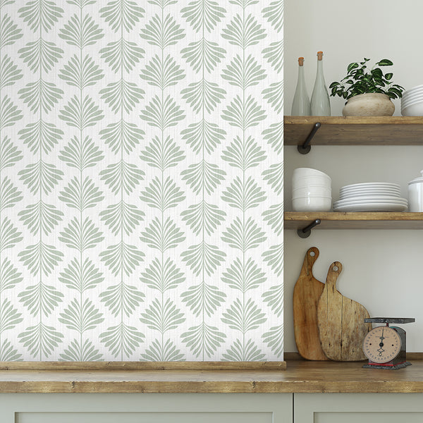 Sage green palm leaf wallpaper with vertically oriented fronds creates a coastal vibe, perfect for kitchens and bathrooms. The removable peel and stick option offers an eco-friendly solution for decorators seeking a modern coastal or transitional style.