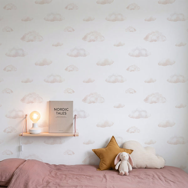 Blush watercolor wallpaper featuring oversized fluffy cloud forms and subtle painted texture for a calming girls bedroom or nursery wall.