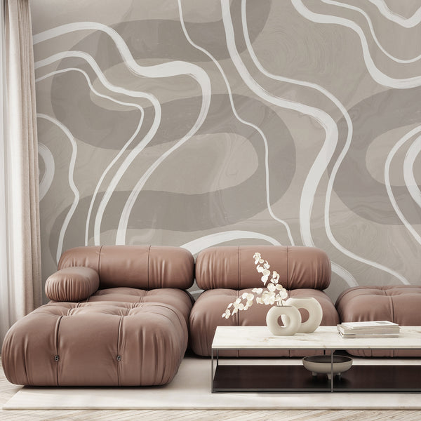 Beige abstract wallpaper featuring oversized white curved lines over a soft textured neutral background for a modern minimalist interior.