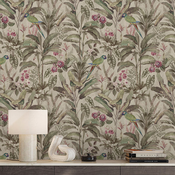 Vintage tropical wallpaper with green parrots, muted pink flowers, lush palm leaves and botanical foliage on a soft neutral beige background.