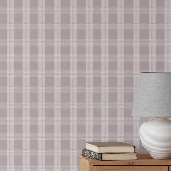 Dusty mauve plaid wallpaper with soft white check lines and an oversized grid pattern, creating a polished cozy look for a nursery or bedroom.