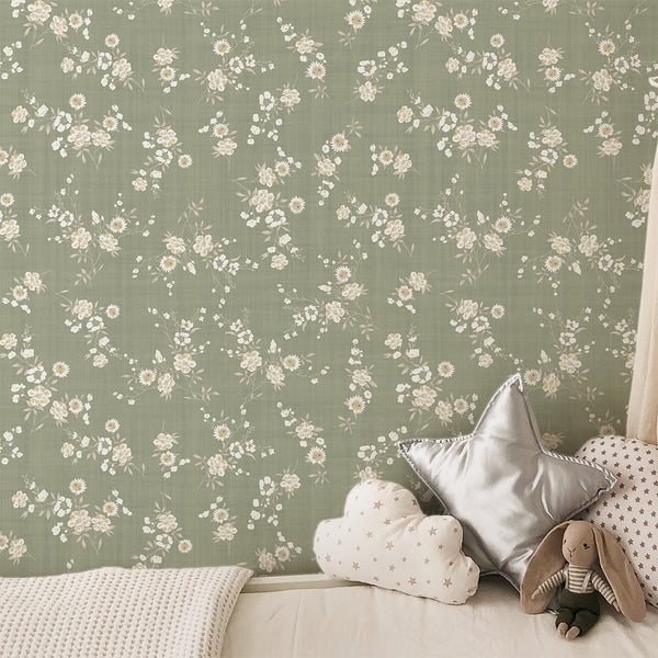 Sage Green Floral Wallpaper features delicate cream and beige blossoms scattered over a dusty sage green ground. The subtle linen-like texture adds a cozy feel to bedrooms and living rooms, perfect for creating a calm, cottage-inspired atmosphere.