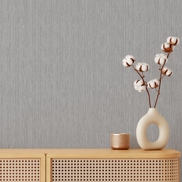 Gray vertical texture wallpaper with fine striations mimicking fabric, ideal for adding subtle depth to living rooms and home offices.