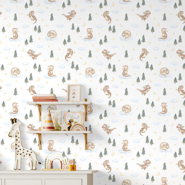 Watercolor dragon nursery wallpaper featuring a cute brown baby dragon sitting on a blue cloud with forest trees, yellow stars and a crescent moon.