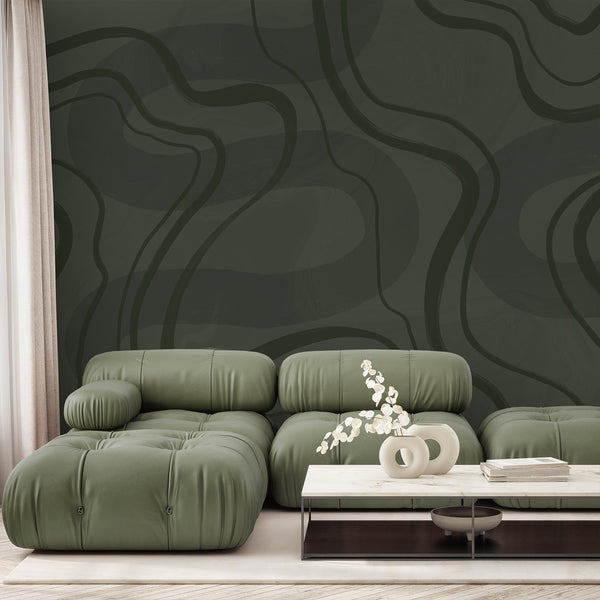 Dark green abstract wallpaper featuring oversized olive curved lines and layered textured green tones for a modern minimalist bedroom or living room.