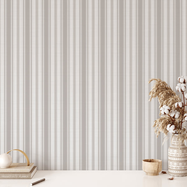 Farmhouse wallpaper featuring muted beige gray vertical stripes with a woven fabric-inspired appearance, bringing understated vintage charm to bedroom accent walls.